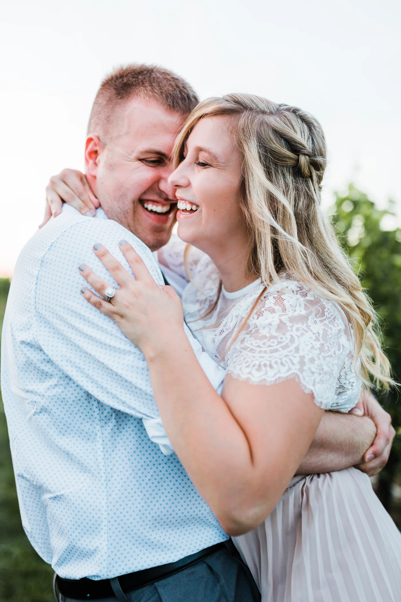 couple laughing together while hugging - maryland engagement photographer