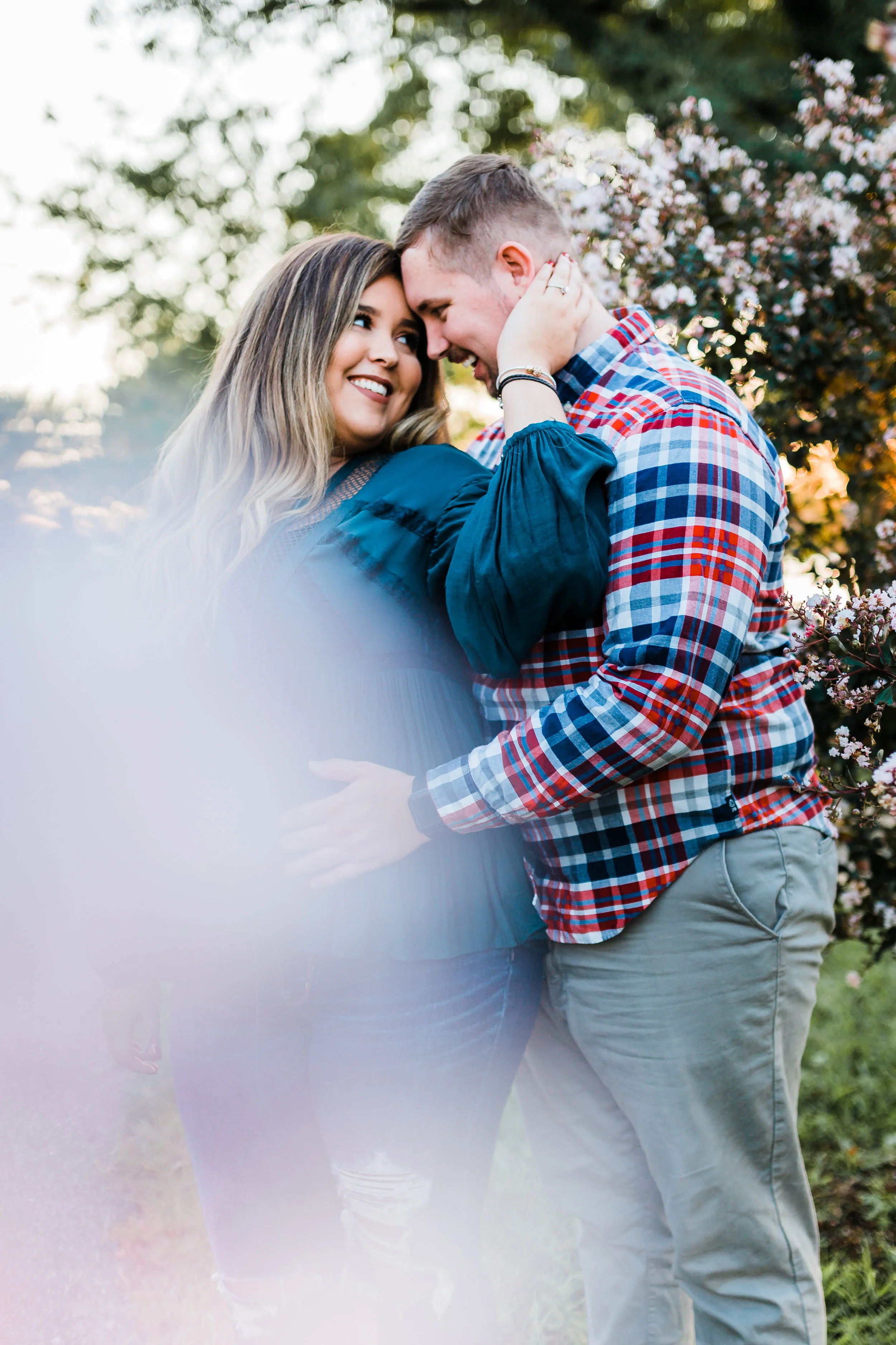 couple during engagement session with cherry blossom tree in annapolis md