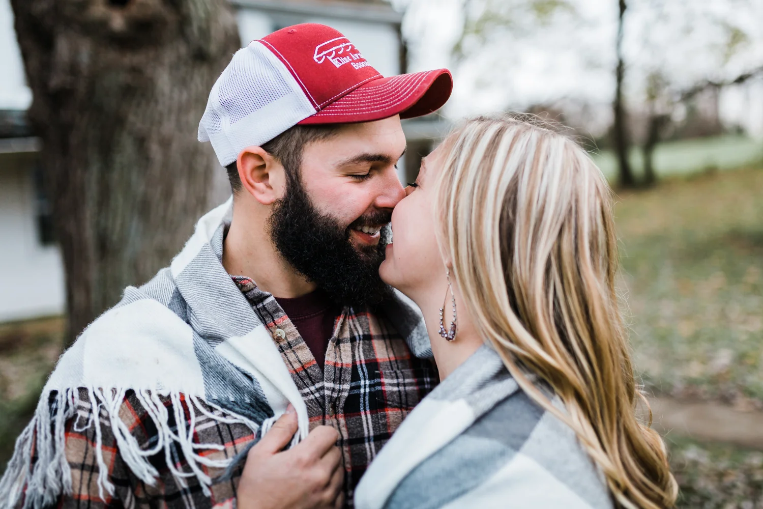 bride and groom snuggling in blanket together during their Frederick engagement session