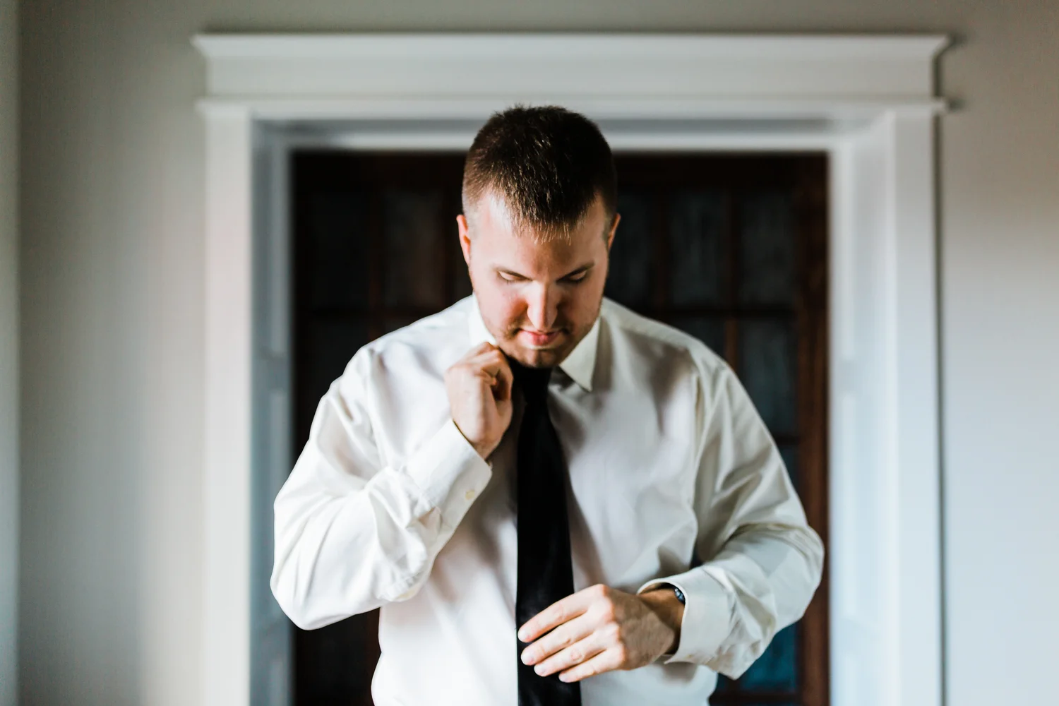 groom getting ready for his wedding at Pond View Farm in White Hall, MD - top MD wedding photographers