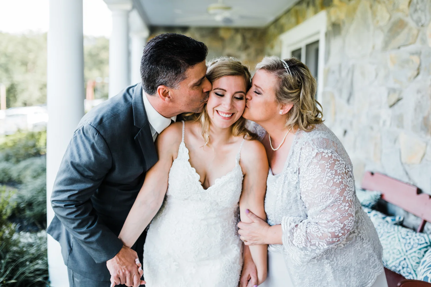 Brides parents kissing her cheeks at Pond View Farm in White Hall, Maryland