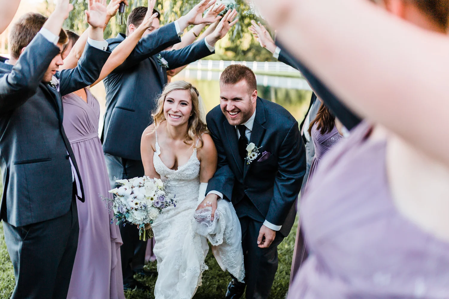 Laughing bride and groom running through - MD Pond View Farm