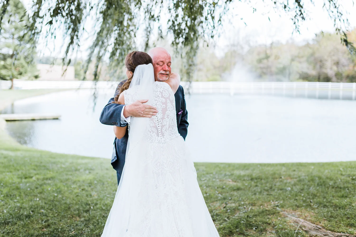 father and bride hug during their first look - Pond View Farm Weddings - best wedding photographer and videographer in Maryland