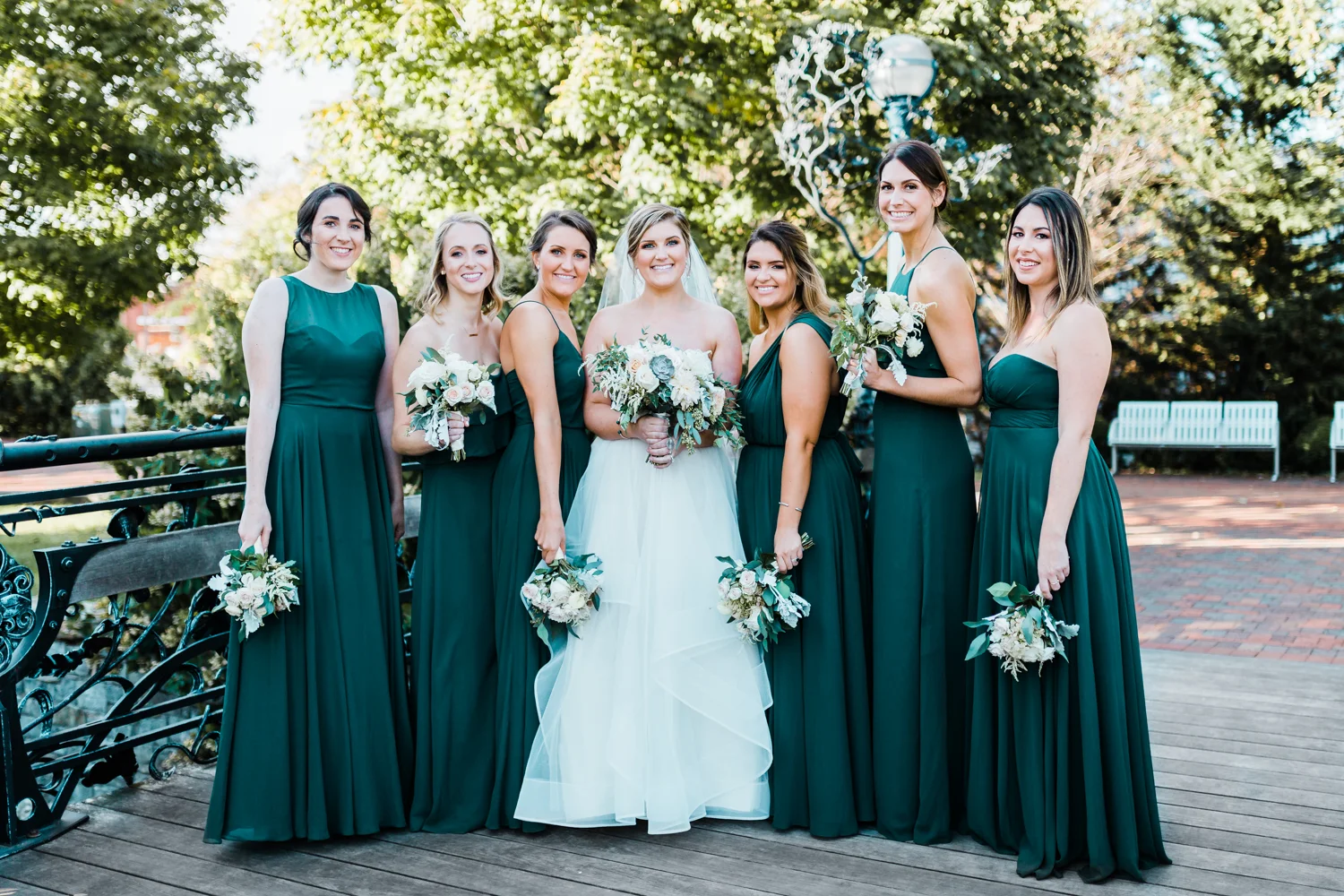bride with her bridesmaids on bridge in Frederick Maryland - green wedding inspiration