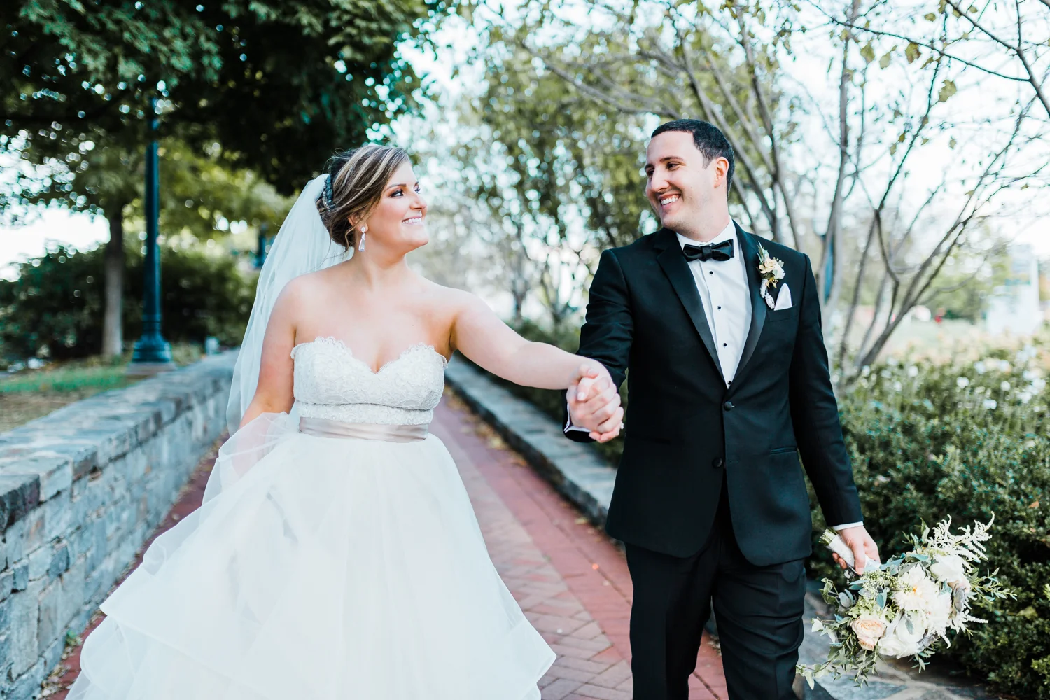 happy couple walking together and smiling - top rated wedding photographer and videographer in Maryland