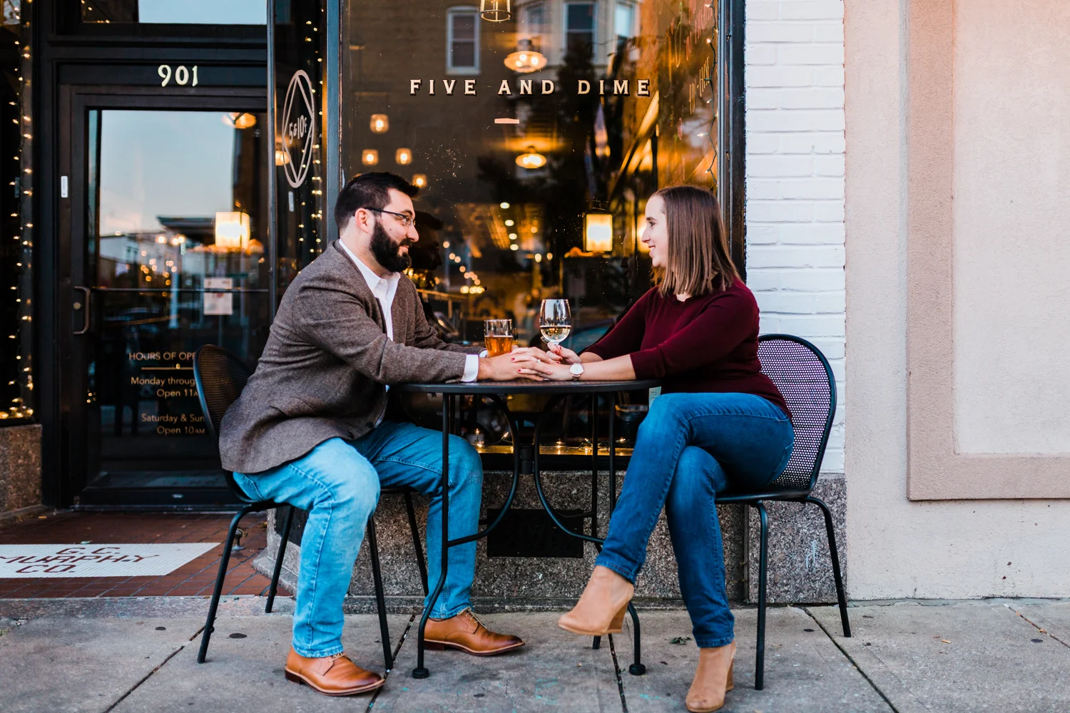 couple outside of Five and Dime during their engagement session - best Baltimore wedding and engagement photographers - husband and wife photo video team