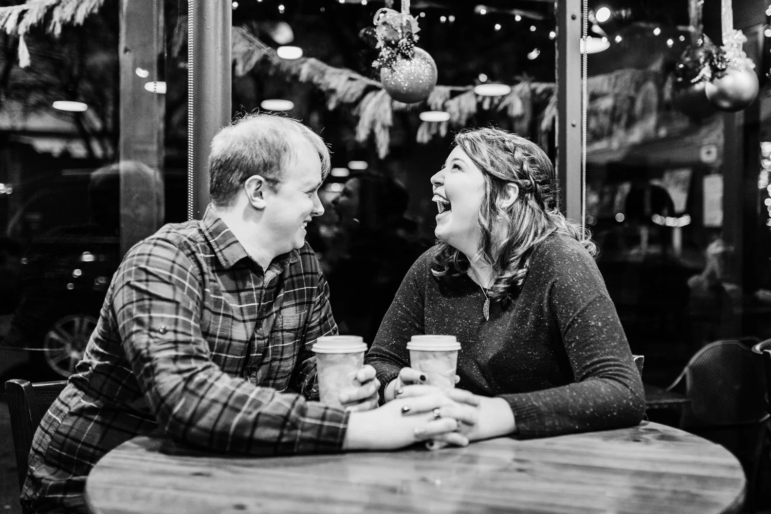 Engagement session couple enjoying coffee at cafe in downtown frederick MD - top rated photographer in Maryland