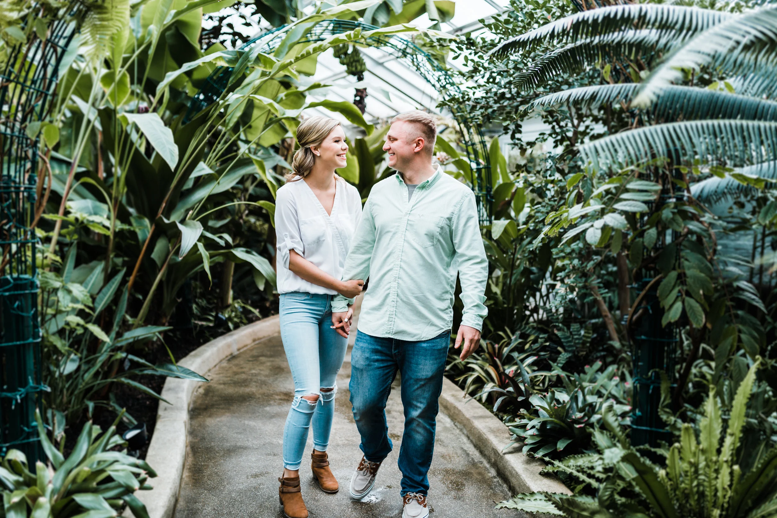 sweet couple holding hands at Rawling Conservatory in Baltimore MD engagement session - top wedding photographers in Maryland