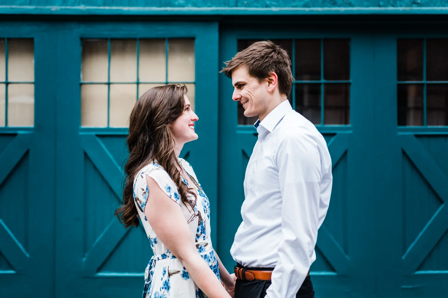 couple smiling at each other during their Baltimore engagement session