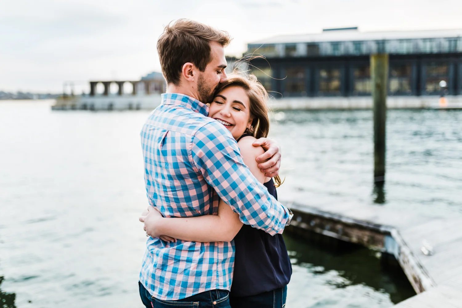 couple hugging each other during their fells point engagement session in baltimore maryland