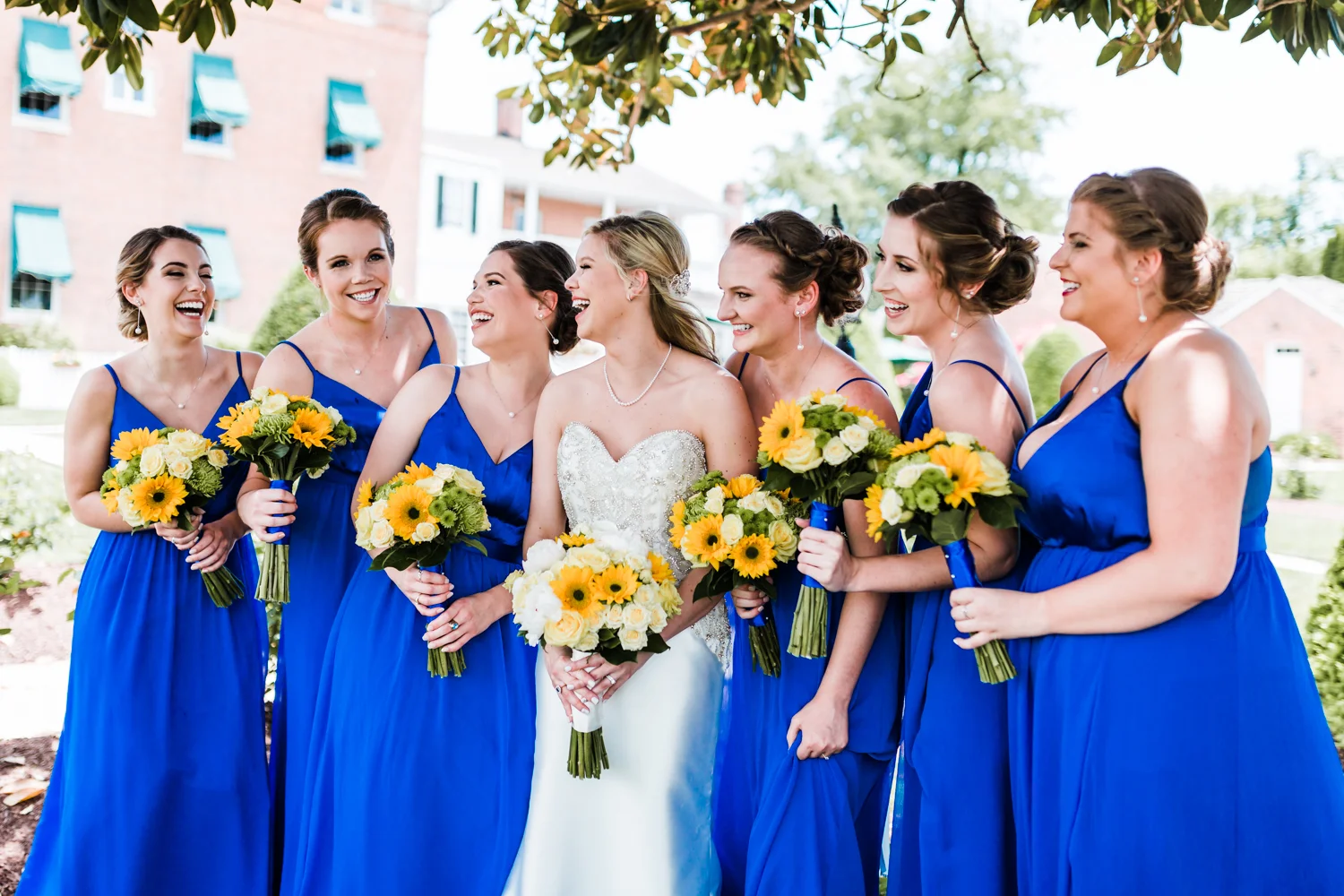 bride with bridesmaids at elegant garden venue - top rated videographer in Maryland