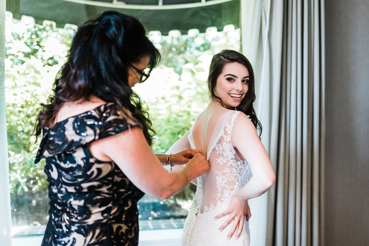bride putting her wedding dress on with her Mom - Annapolis waterfront hotel weddings