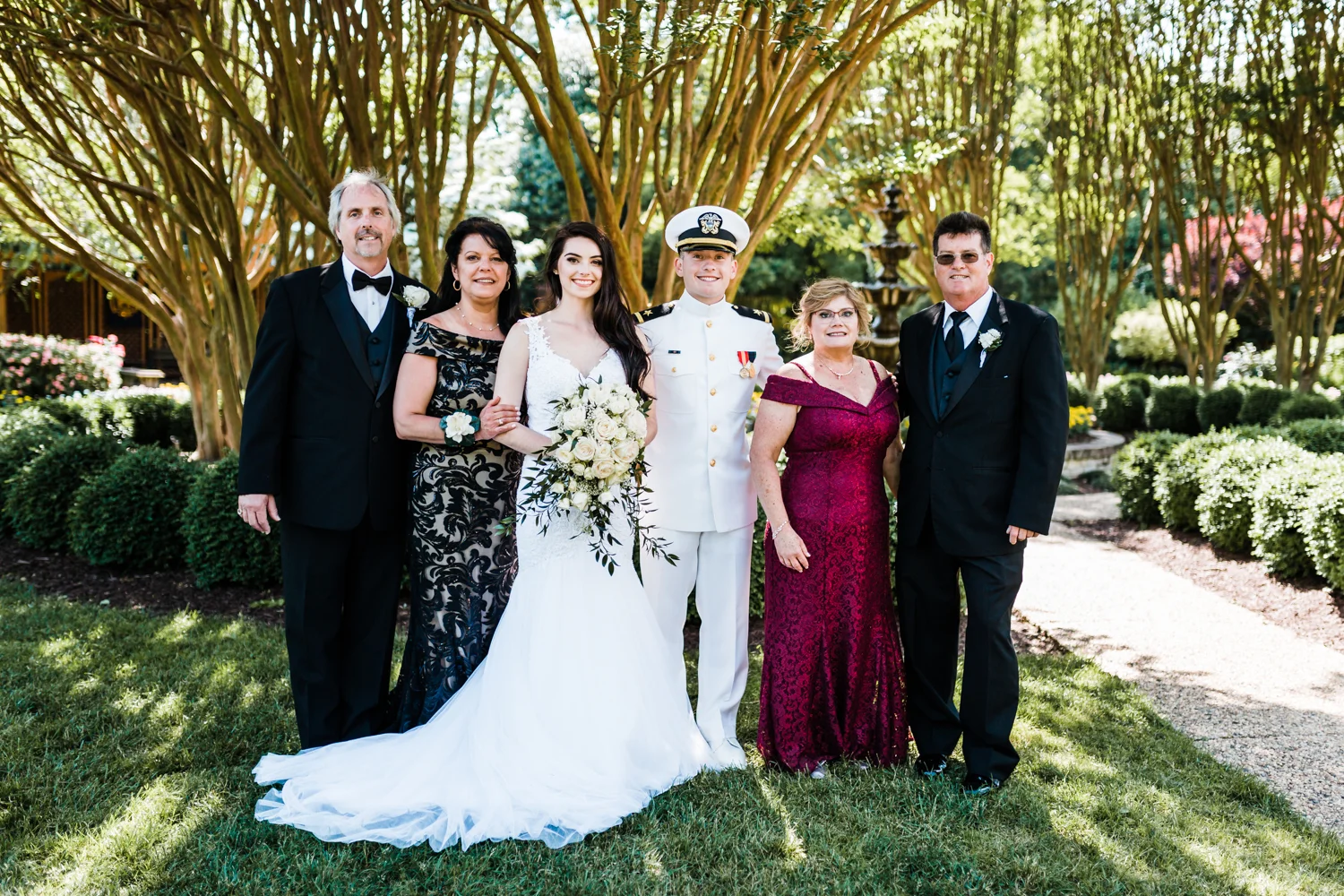 bride and groom with both of their parents