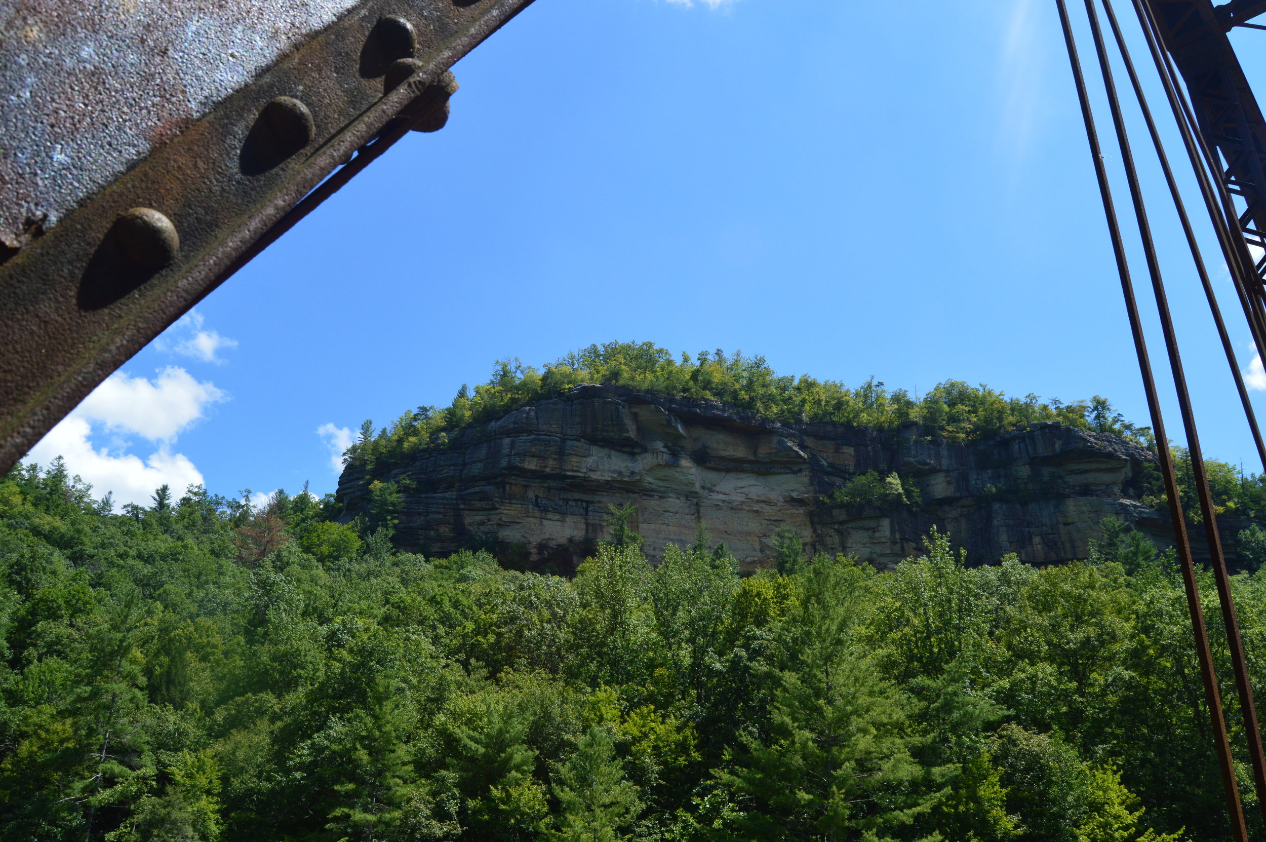 A large rock wall lines the top of the ridge just above the trail to the O&W Bridge.