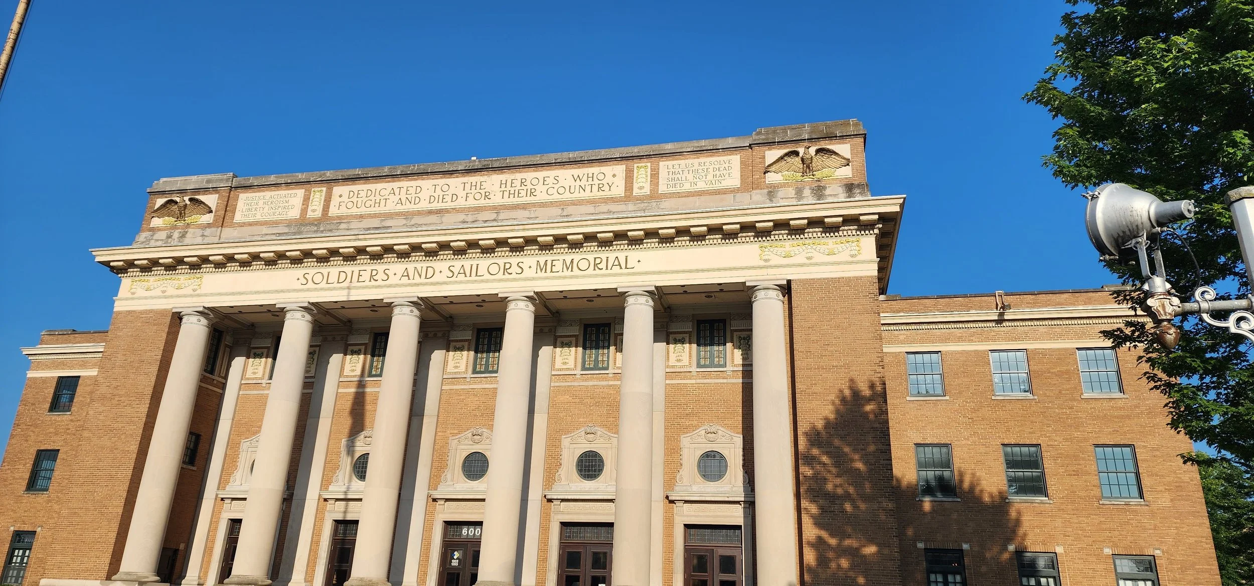 Large brick building with tall columns with soldiers and sailors memorial inscribed on the front