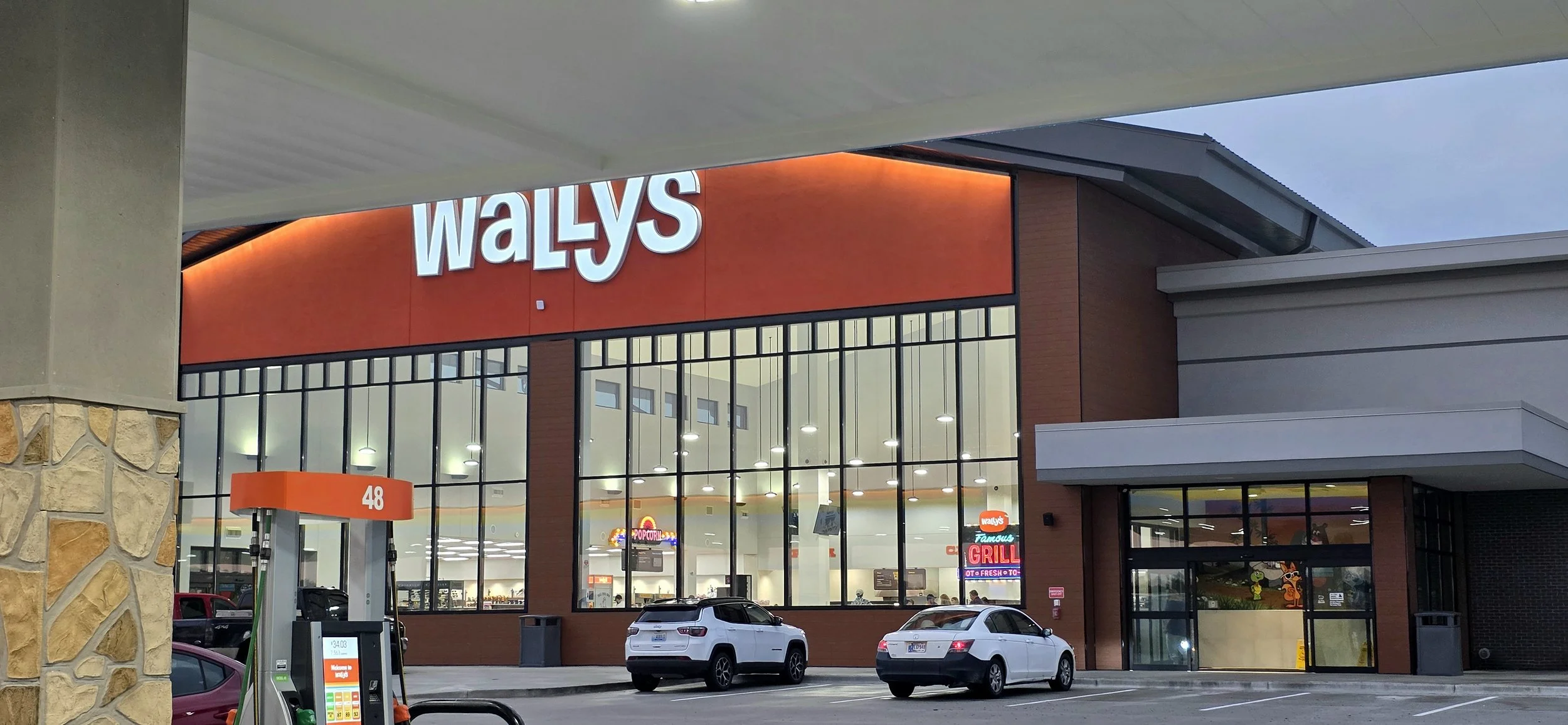 large building with lots of glass on the outside. wallys is spelled out in white letters on an orange background