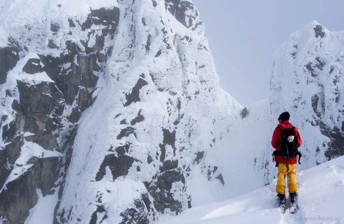Fabi looks on as Neil scrambles up a chute to access their next line