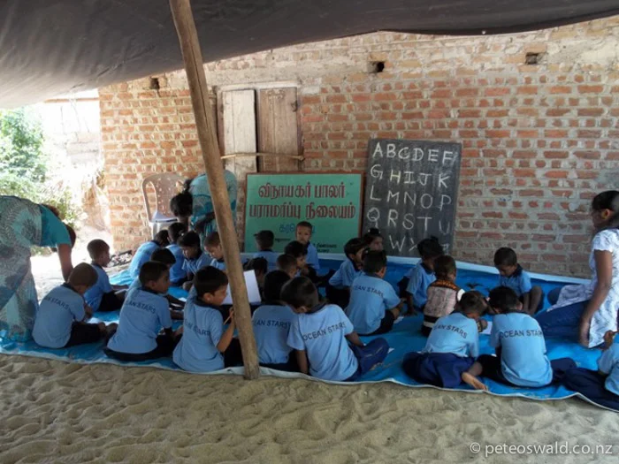 Students at the Karaveddy Preschool after a storm in 2011 ripped off the roof.