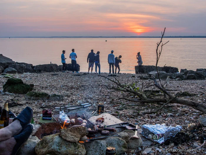 L-R: Sam Pickard’s feet, Chris Newnham, Frank Bagnall, Will Carter, Claudia Manser, Doug Newell, Doug Richards and Vic Degan having a BBQ on the beach with many others not pictured