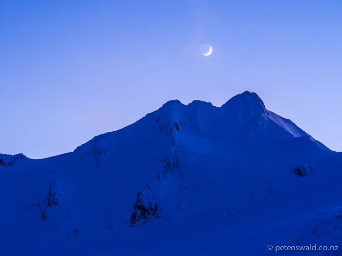 In the first light the moon sits above the Brewster peak