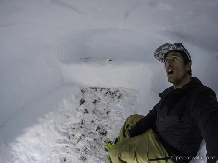 Inside the snow cave I built with a bed and candles at the back. The door to the cave is just to the right of the bar in the photo above
