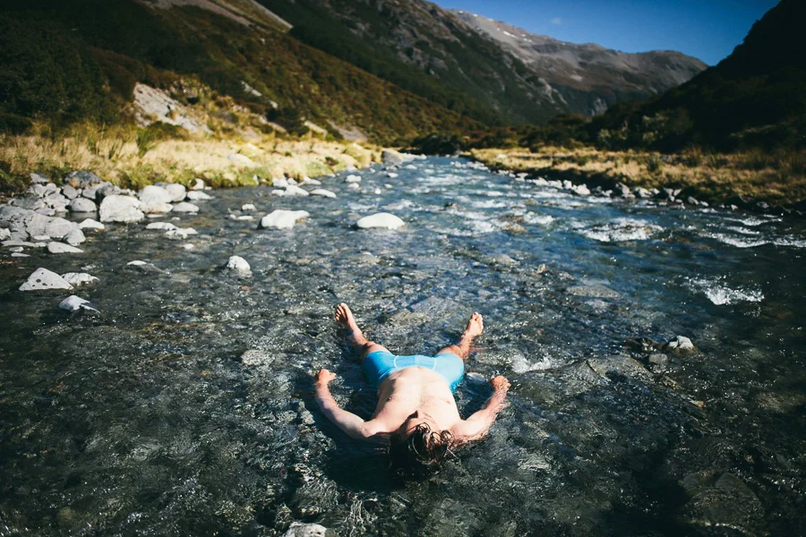 Pete cools down and washes off in the ice cold river. Photo: Tom Powell