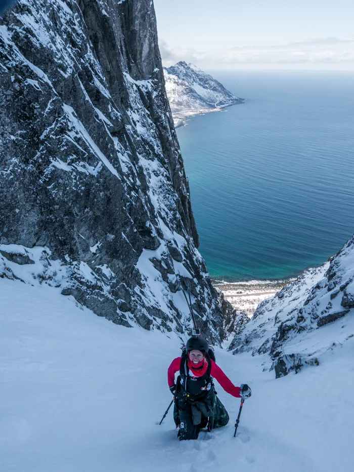 Tove finally gets to the top of a long skinny couloir that drains to the sea. Photo: Pete Oswald