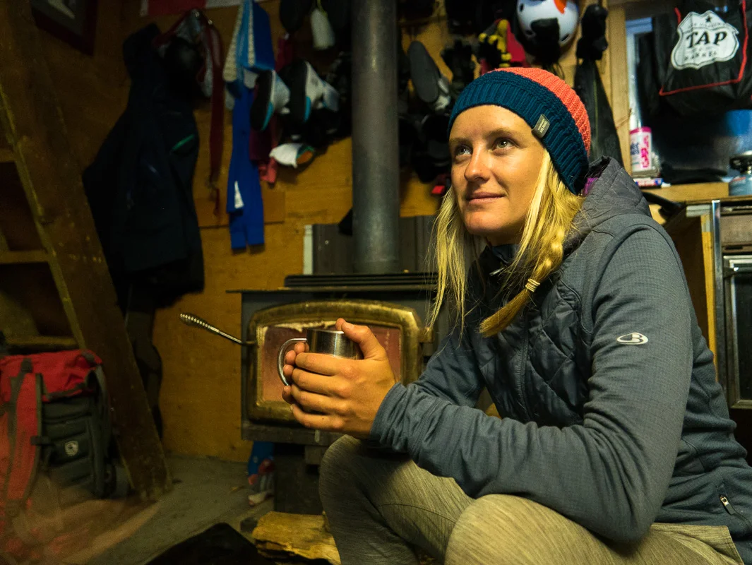 Soph enjoying the cosy hut by the fire. Photo: Pete Oswald