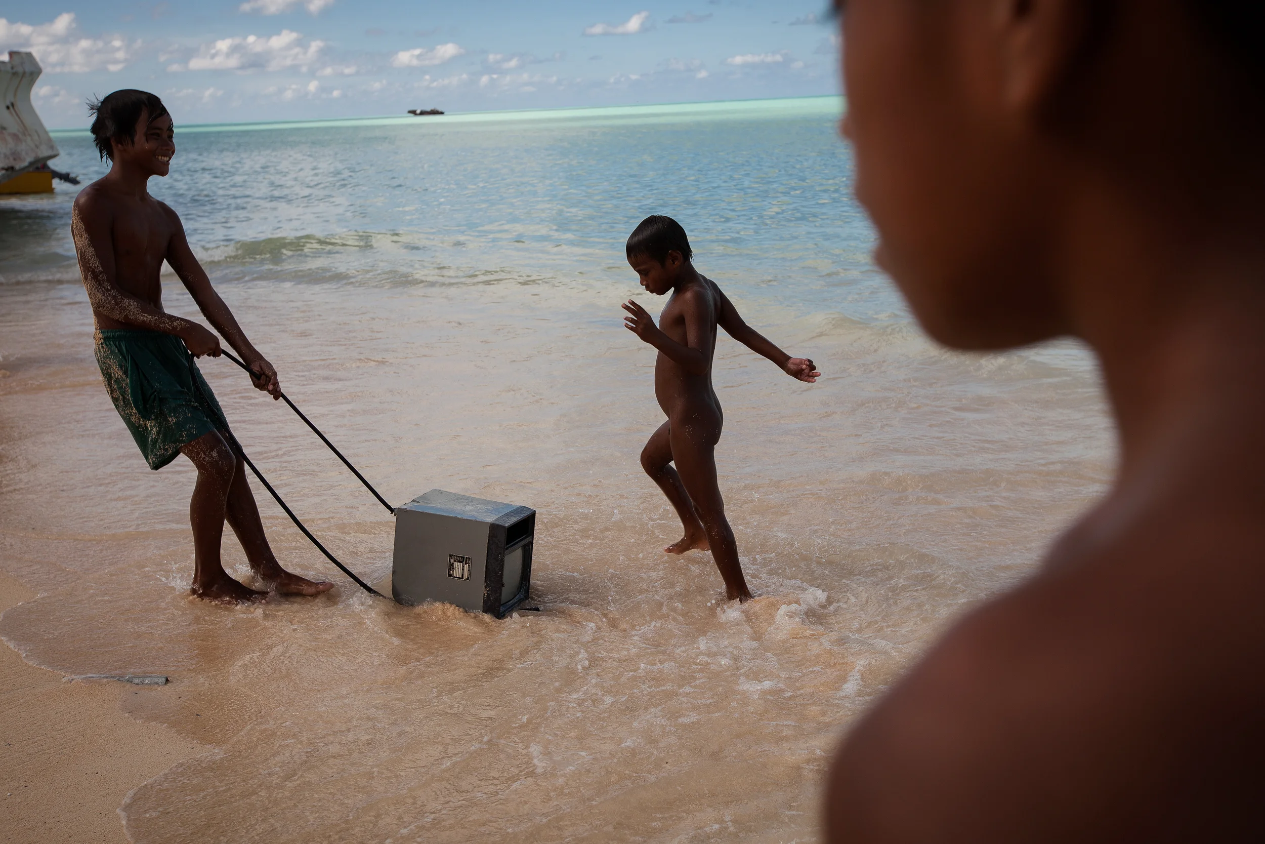 Children play with an old monitor that has washed up on the shore at Red Beach in South Tarawa. Every day, the hide tide brings in all manner of rubbish. With virtually no hard (or soft) waste management in Tarawa, the island suffers from a serious pollution problem.