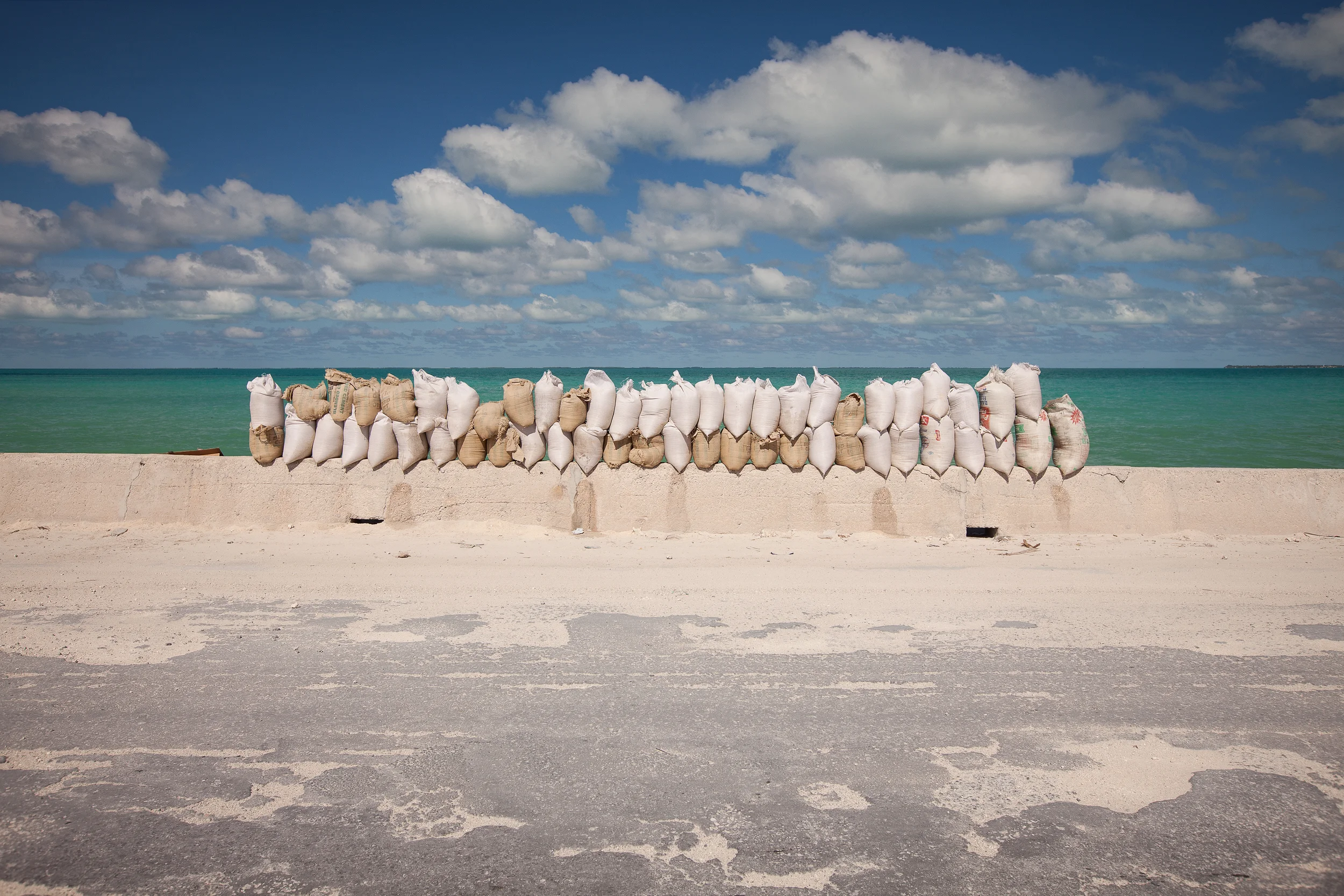 Sandbags pile up on the Betio causeway. There is only one road going from one end of Tarawa to the other, making it a crucial piece of infrastructure. The thin causeways linking bits of land together are particularly vulnerable to storm surges and waves, and require regular maintenance.