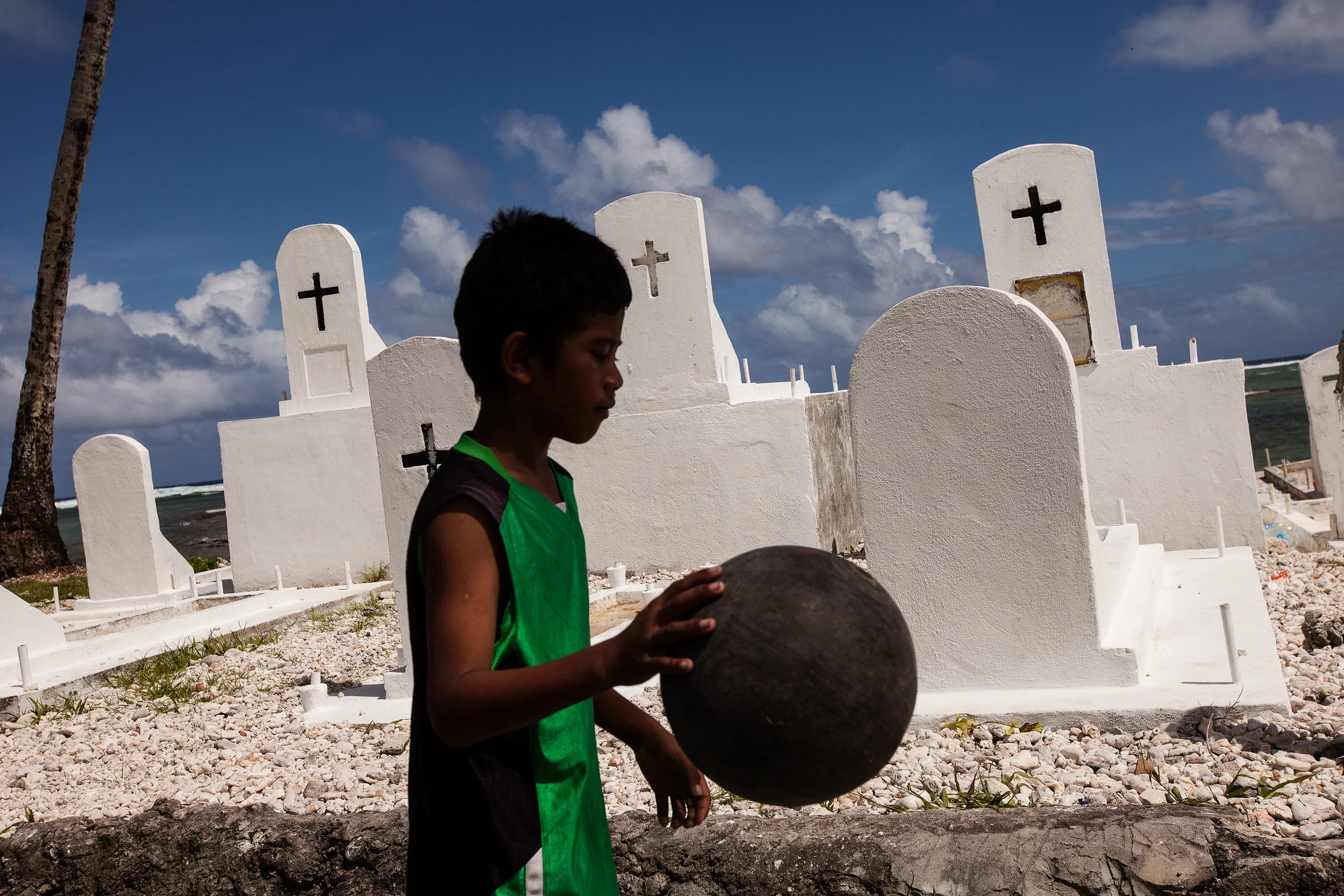 Cemeteries like this are scattered about the island of Majuro. With such a small area of land to a relatively high population, there are only so many places to bury the dead, and many graves have been washed into the ocean as the seas rise.