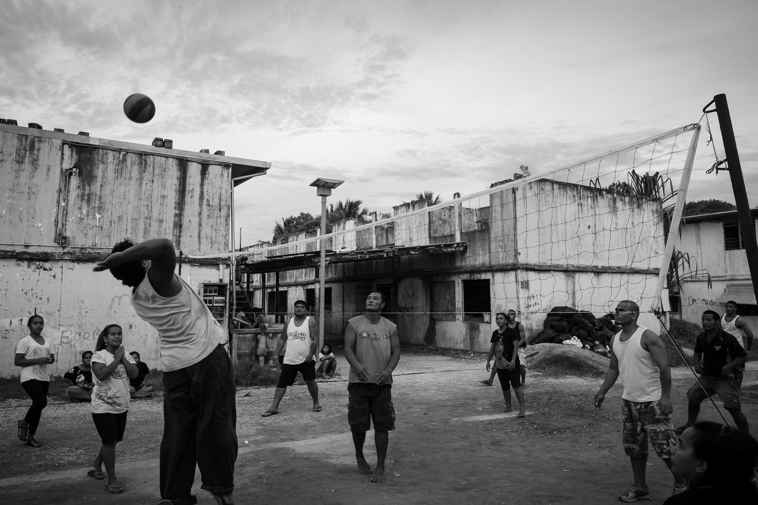 Locals play volleyball in Location Block. Many of the locals who live in this area actually own land elsewhere on Nauru that is used by the detention centres. They live here because it is cheap and the money they collect for the lease on their land elsewhere is enough for them to live on.