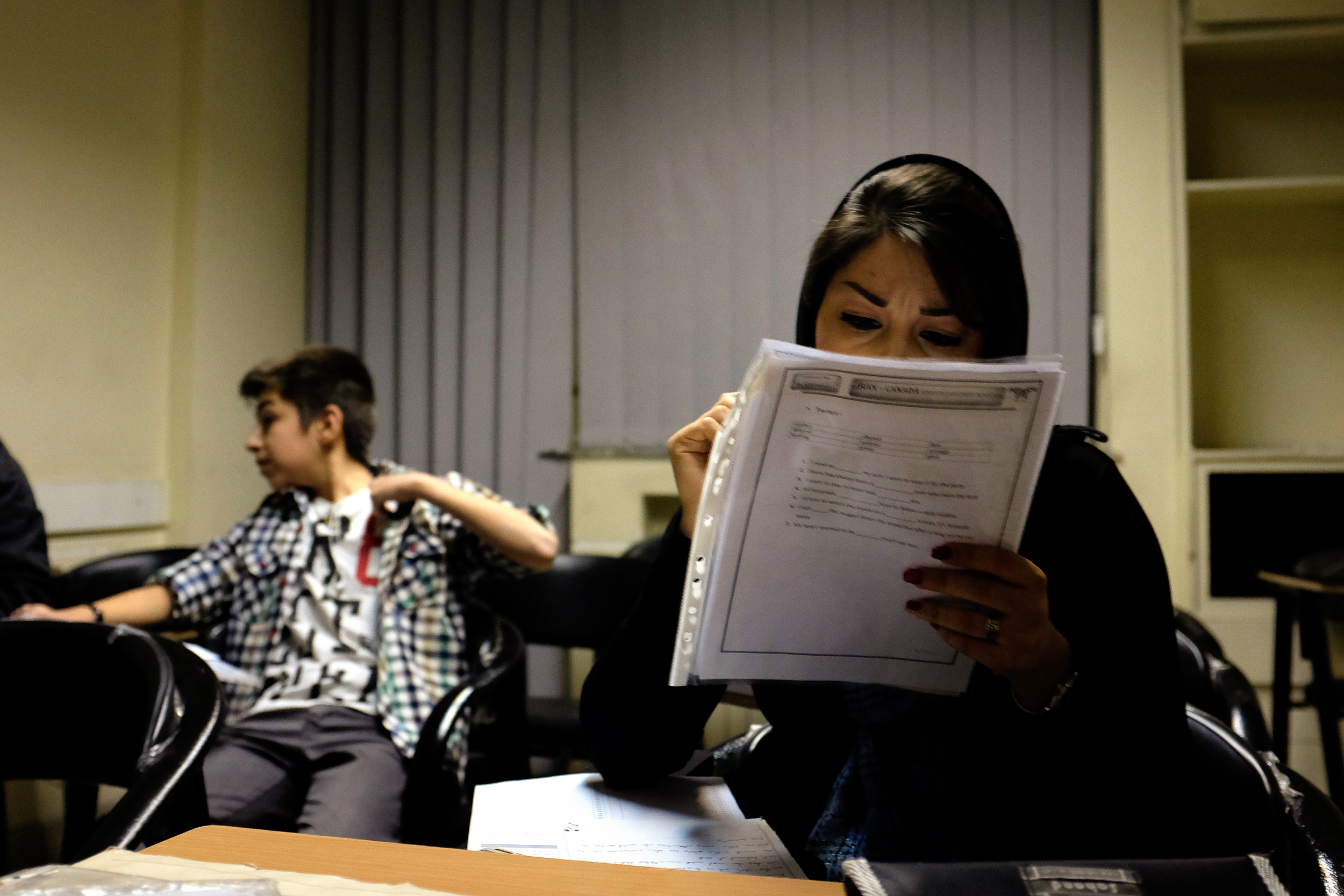 Students finish an exam at the Iran-Canada Institute of Languages. Education is valued very highly in Iran and is seen as a 'way out'. Many of the younger students in this class are doing this English course outside of their normal schooling.