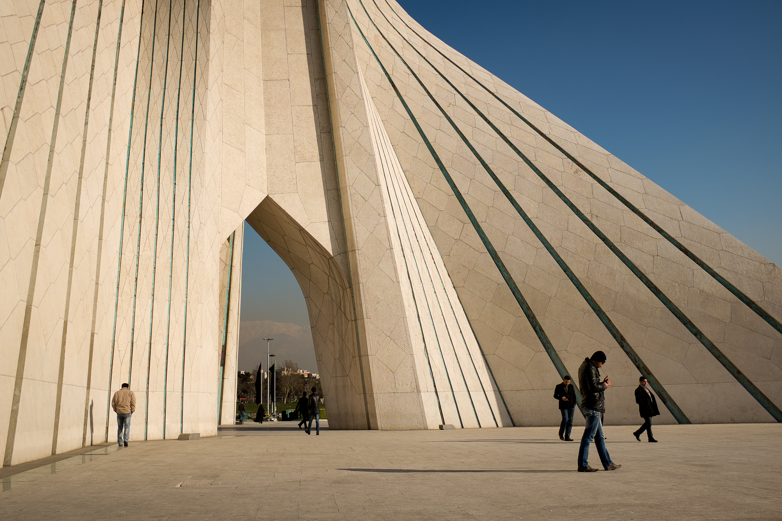 Men make their way around the gateway to Tehran, the Azadi Tower. Hossein Amanat, the architect of Azadi Tower, which translates to 'Freedom Tower', had to flee Iran eight years after the completion of his masterpiece because he was a member of the persecuted minority Baha'i.