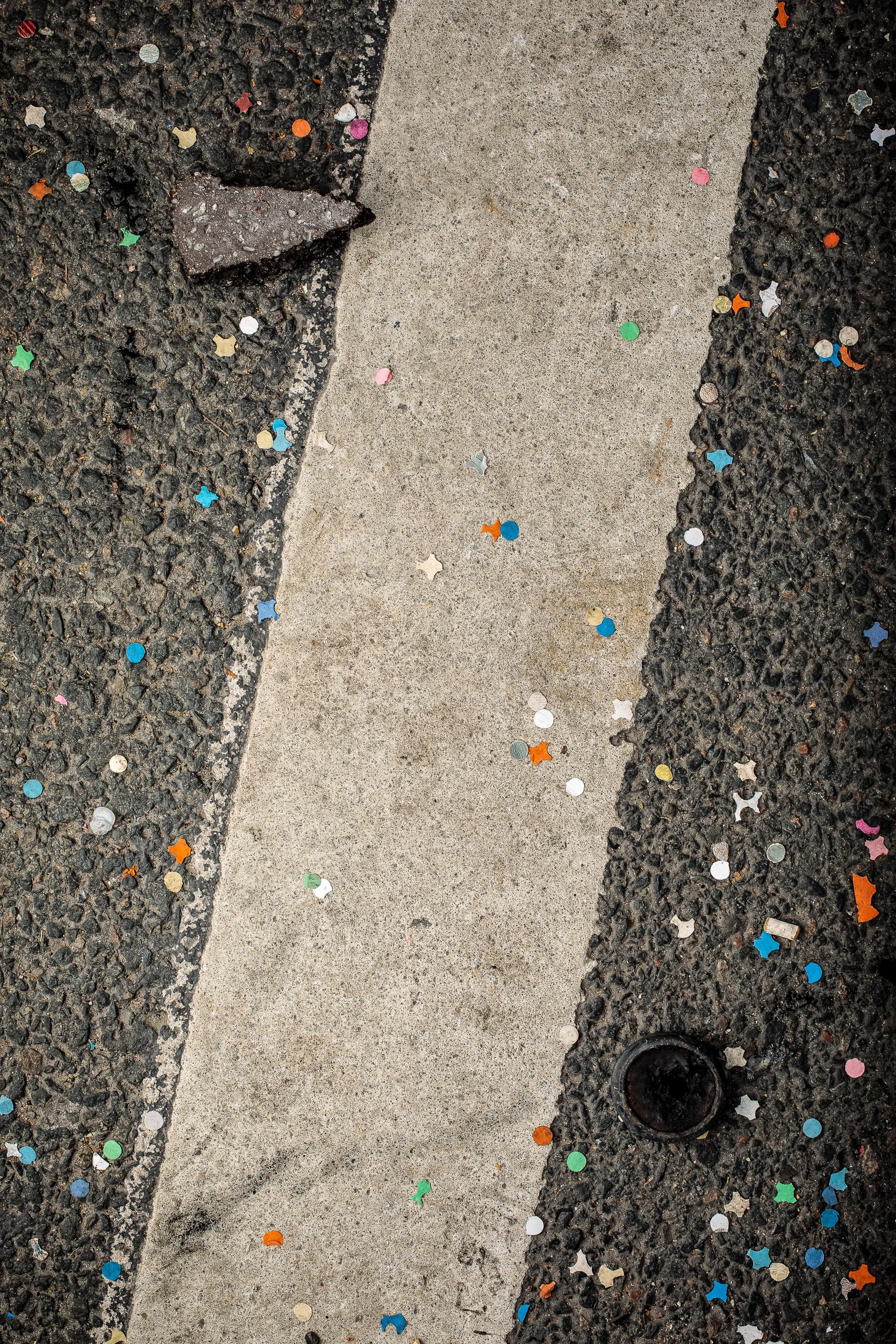 Tear gas canister, cement block and confetti, 2018