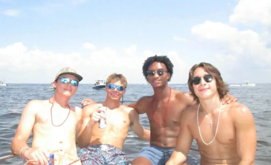 Nolan Wells, second from right, poses with three friends on a boat during a July 4 outing to Horn Island off the Mississippi Gulf Coast.