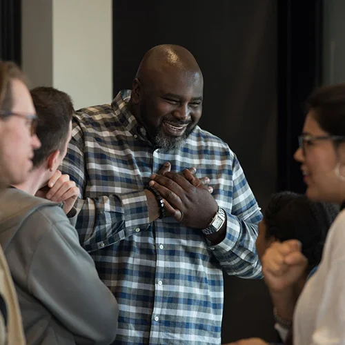 Edrin Williams, associate pastor, talks with people during a Sunday morning worship service at Sanctuary Covenant Church. (Credit: Angela Jimenez for MPR News)
