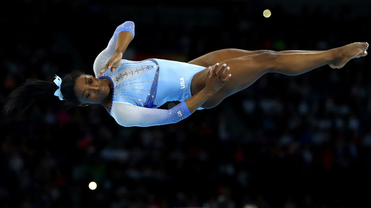 Simone Biles performs on the floor exercise during qualifying sessions for the FIG Artistic Gymnastics World Championships in Stuttgart, Germany. (Credit: Matthias Schrader, AP)