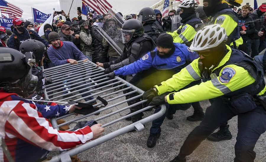 Trump supporters try to break through a police barrier, Wednesday, Jan. 6, 2021, at the Capitol in Washington. (AP Photo/John Minchillo)