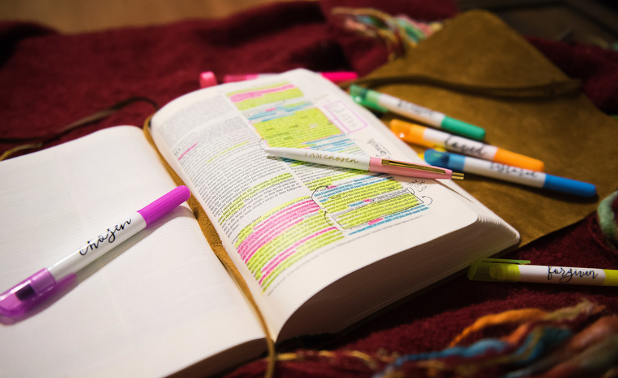 An open Bible richly highlighted and annotated with colorful markers and journaling pens, illustrating devoted, hands-on study of Scripture