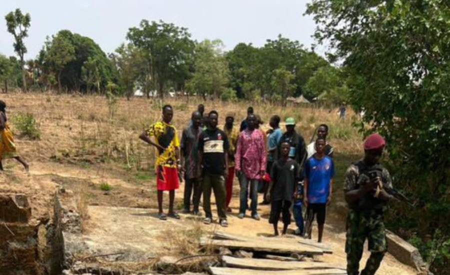 Residents and a Nigerian soldier in Ariko Village, Kaduna State, following an Easter church attack and rescue operation.