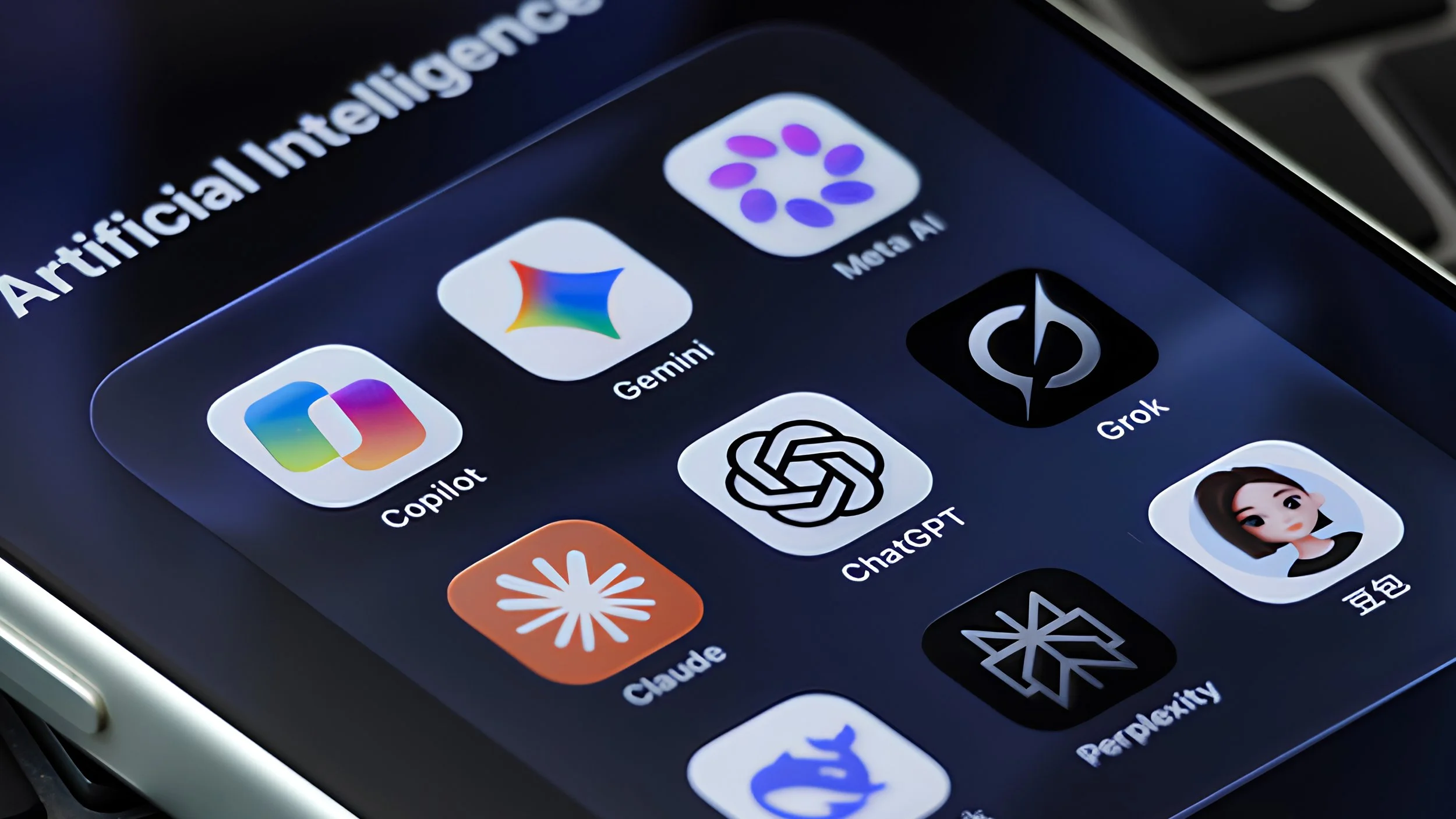 A smartphone folder labeled “Artificial Intelligence” holding app icons for Copilot, Gemini, Meta AI, Grok, ChatGPT, Claude, Perplexity and other AI chatbots.