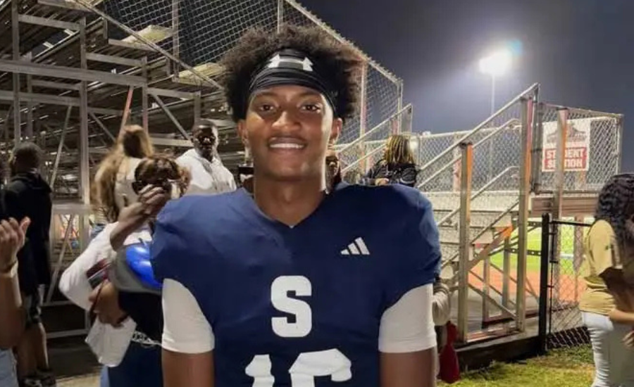 Nolan Wells smiles in his football uniform near the bleachers at a nighttime game. Wells played wide receiver at Southwest Mississippi Community College.