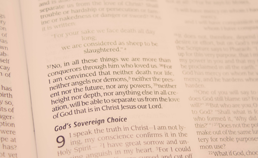 Close-up of an open Bible showing the end of Romans 8 and the beginning of Romans 9, under the heading “God’s Sovereign Choice.”