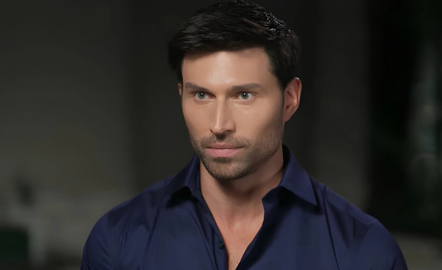 Derek Dixon in a navy button-down shirt during a television interview