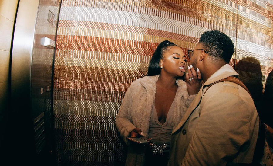 Marlon Moore, known as DJ ASAP, whispers to LaShonda Moore as they stand together in an elevator