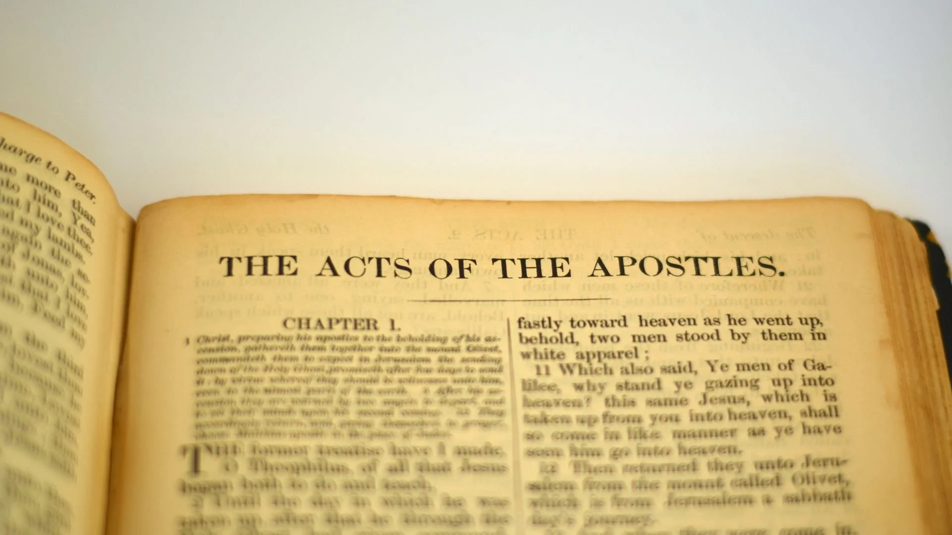 An aged King James Bible open to the first chapter of the Acts of the Apostles.
