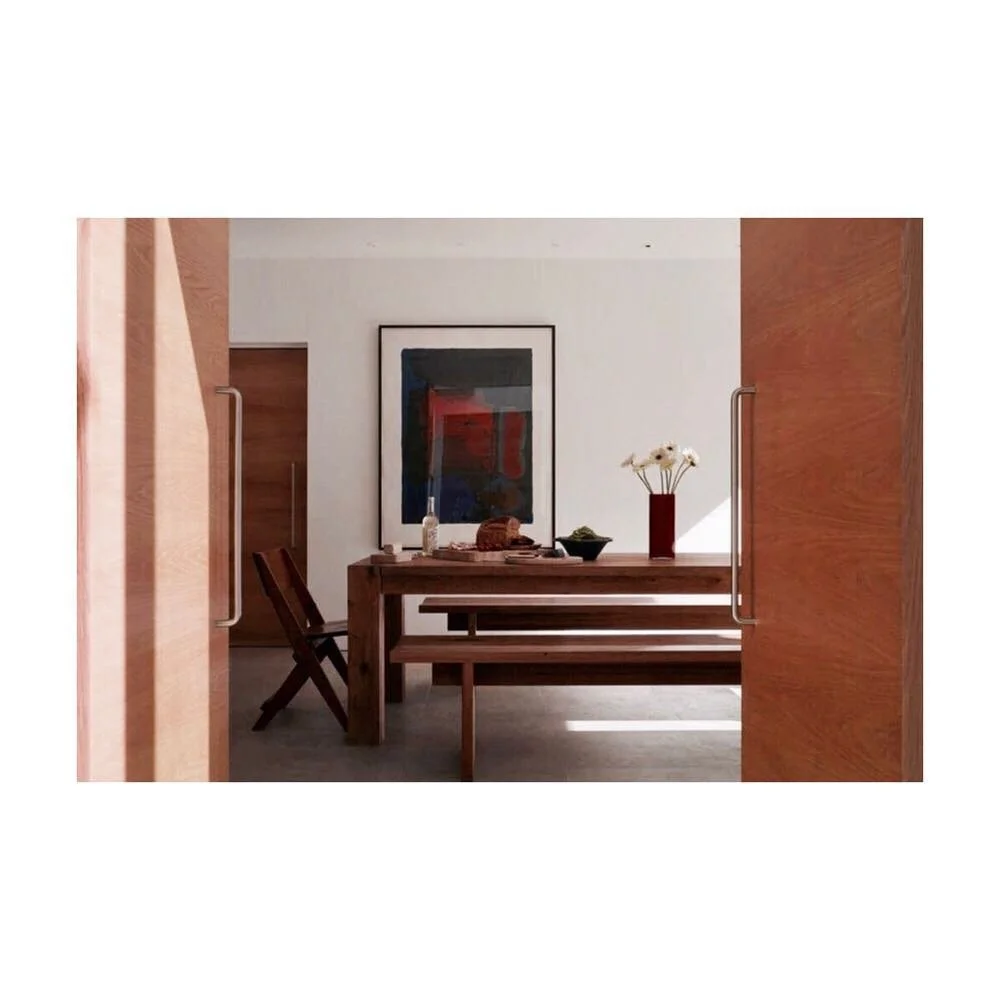 The use of wood gives this minimal space a sense of warmth #wood #table #warmth #materials #art