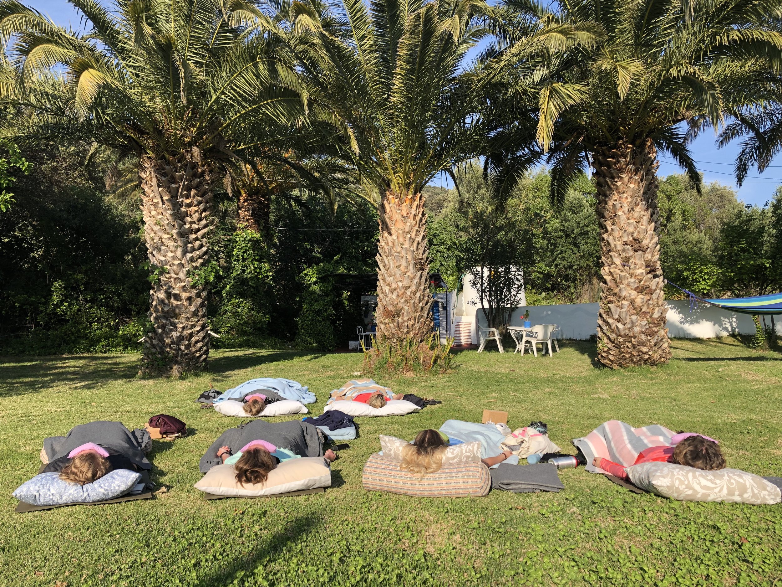 Yoga Nidra under palmtrees at Yin Yang Yoga retreat in the Malaga mountains in Spain with Jane Bakx Yoga