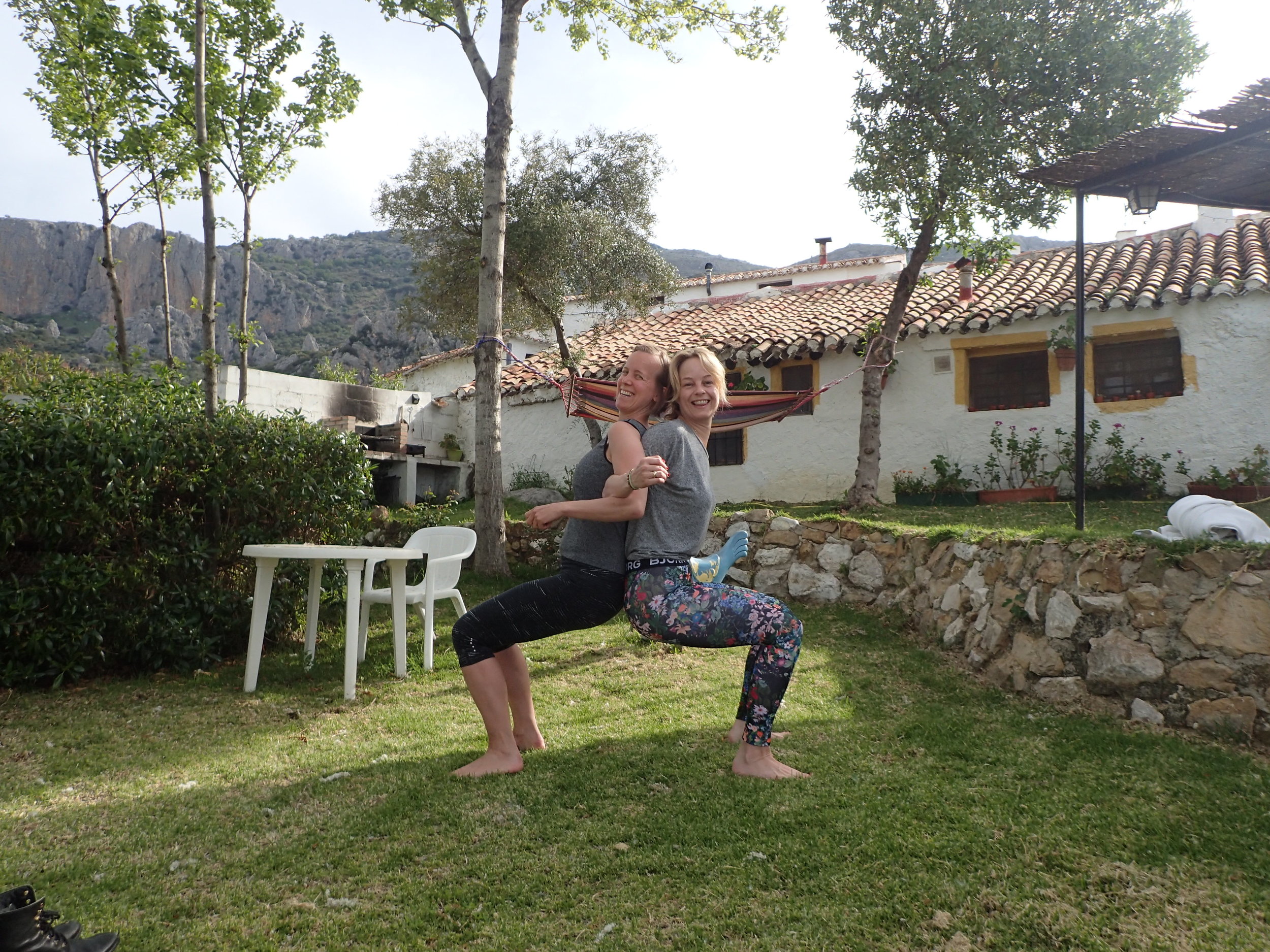 Partner Yoga in garden Yin Yang Yoga retreat Malaga mountains Spain